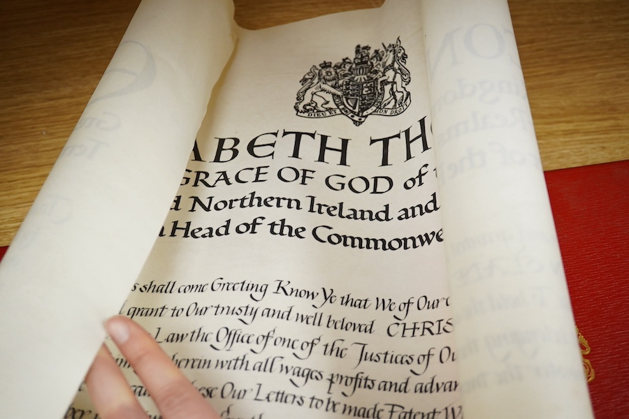 The Hon. Lord Justice Slade, ‘A Writ of Attendance at Parliament’, two vellum documents with ERII red seals in a red fitted case with a gold Royal Coat of Arms stamp, case 59cm wide x 23cm deep. Condition - some foxing